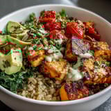 Savory Customizable Grain Bowl featuring brown rice, chicken, chickpeas, and crisp fresh veggies.
