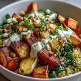 A vibrant Hearty Winter Grain Bowl featuring roasted root vegetables and wilted greens, drizzled with creamy tahini dressing for a cozy main dish.  