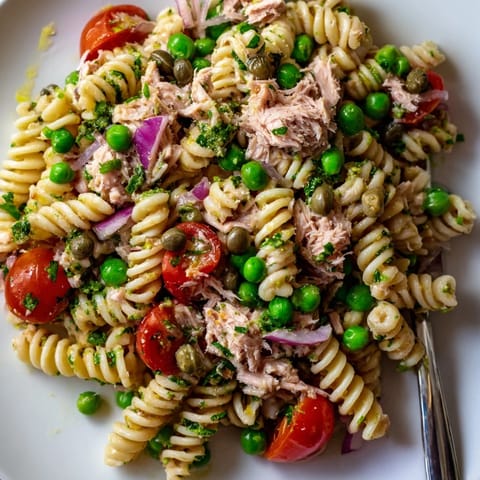 Bright lemon dressing coats flaky tuna and al dente pasta, with sweet peas and fresh dill for a refreshing, easy salad.