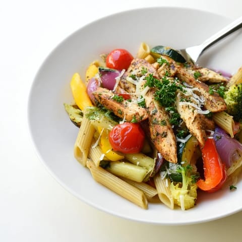 Roasted garlic herb chicken and vegetables tossed with penne pasta in a light, aromatic sauce.