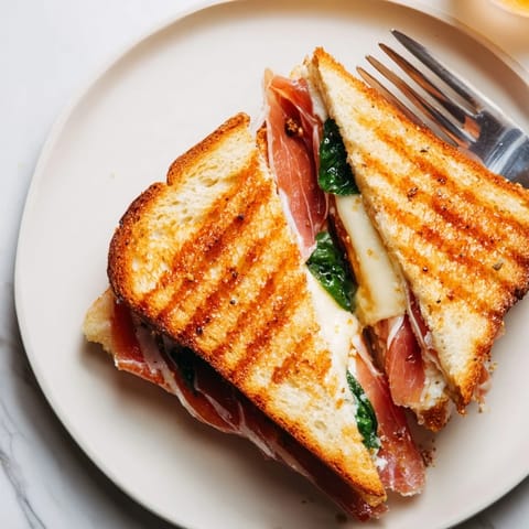 Slices of golden, buttery sourdough hold crispy prosciutto and creamy burrata in this luxurious grilled cheese.  