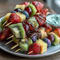 Fun Kid Lunch Bento Box with Fruit Skewers and Dip features colorful fruit skewers, creamy yogurt dip, and playful sandwich shapes for a nutritious and fun meal.